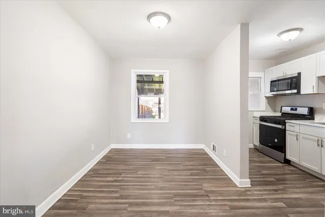 a view of kitchen with sink and wooden floor