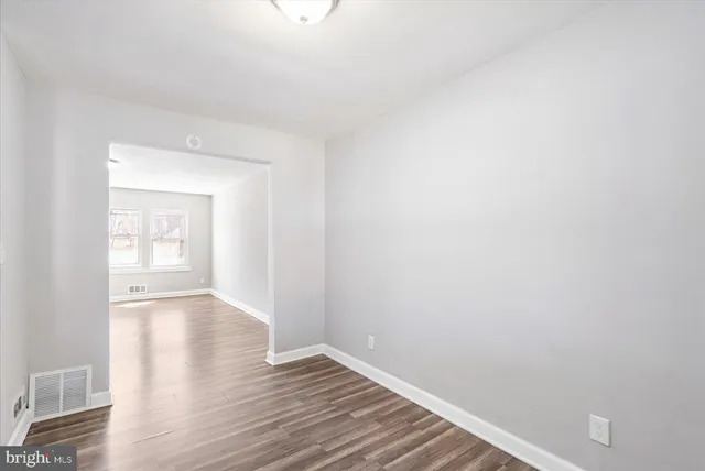 a view of an empty room and wooden floor