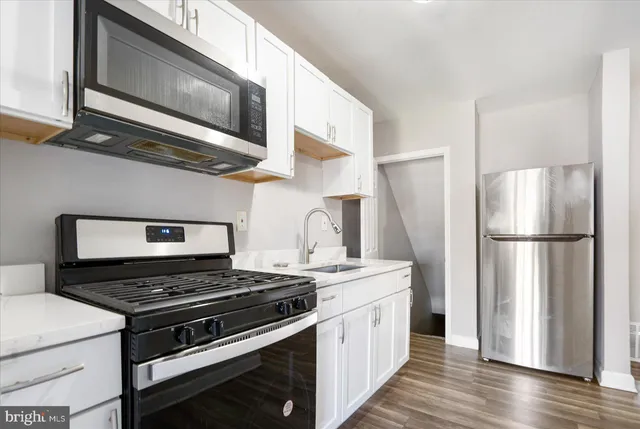 a kitchen with stainless steel appliances a stove a microwave and a refrigerator