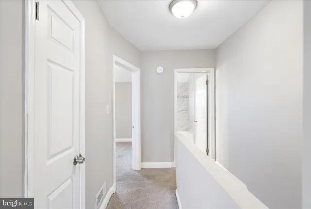a view of a hallway with white walls