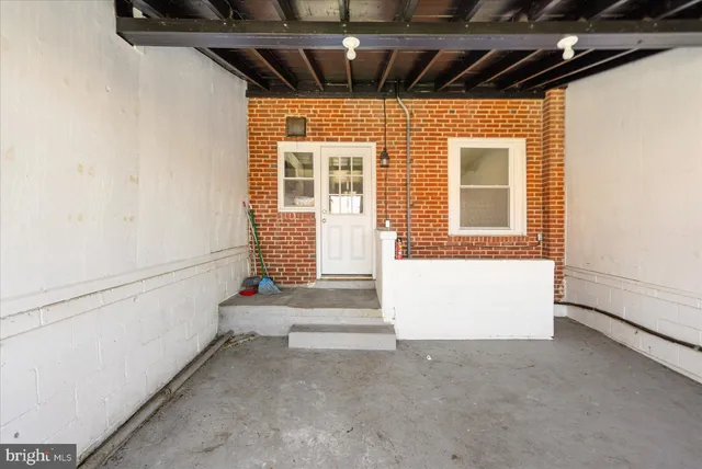 a view of porch with a door and a refrigerator