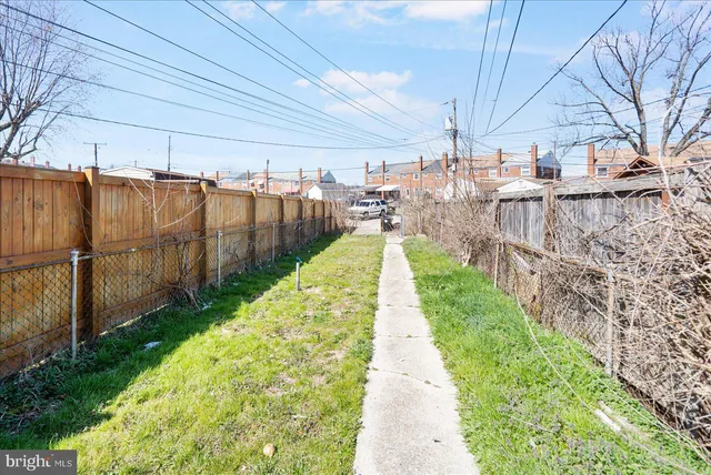 a view of a backyard with wooden fence