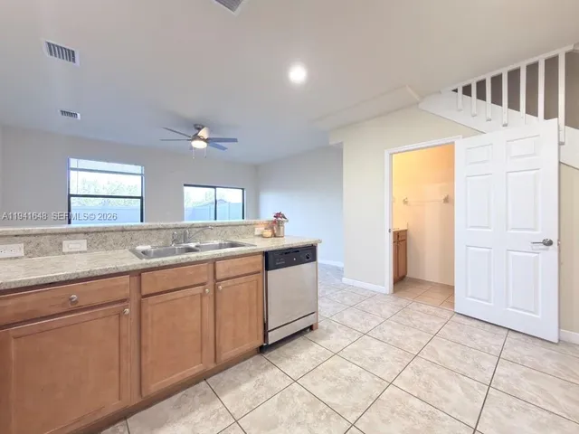 a view of a kitchen with a sink and a window