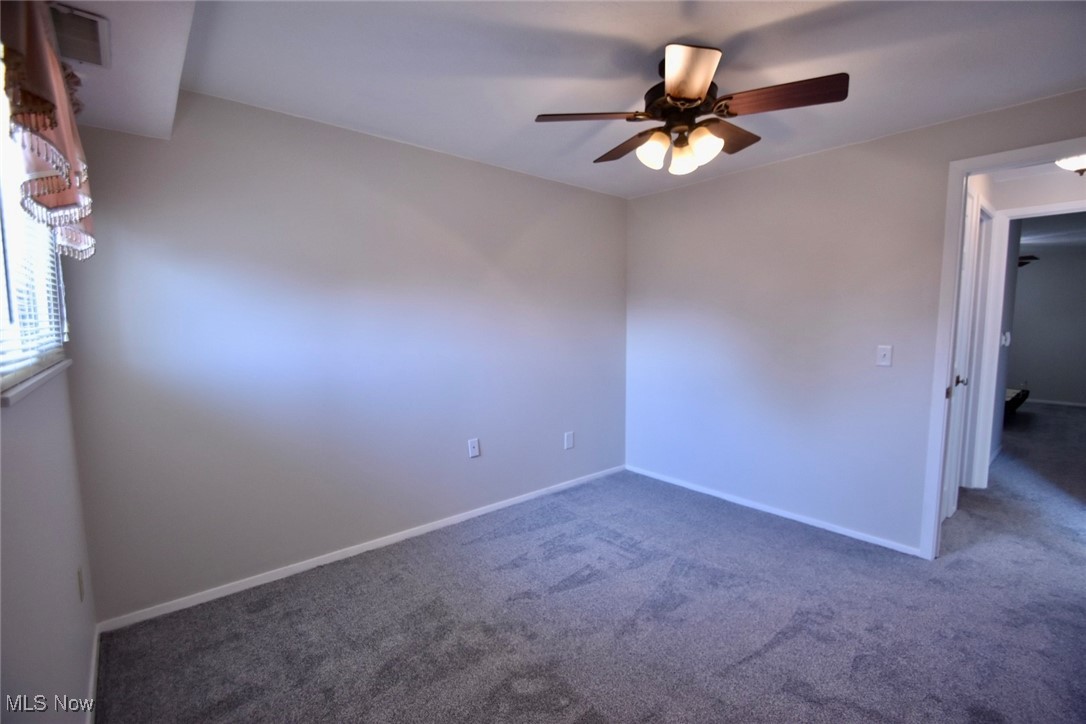 8955 West Ridge Road, Unit D Elyria, OH 44035 - Photo 28 of 33 Empty room with carpet flooring and a ceiling fan