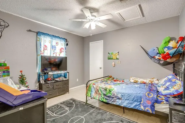 a kitchen with refrigerator and cabinets