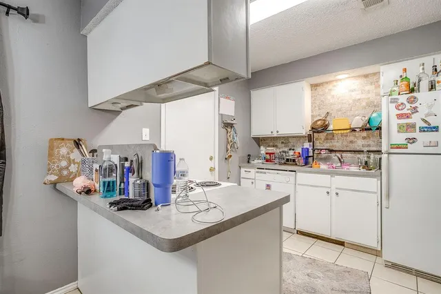 a kitchen with stainless steel appliances a sink and cabinets