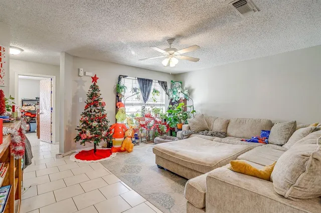 a living room with furniture a couch and a bookshelf