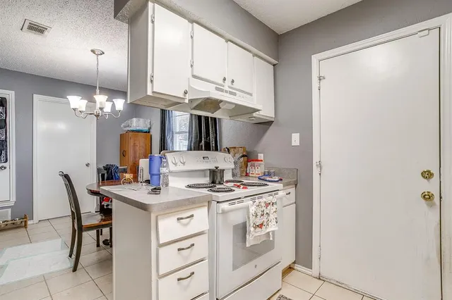a kitchen with a table and chairs in it