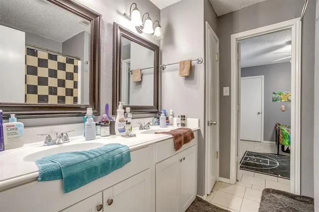a bathroom with a double vanity sink and a mirror