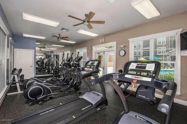 a room with gym equipment and windows