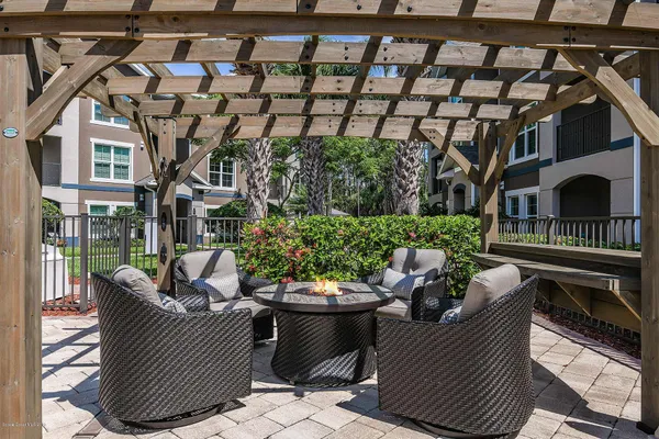 a view of a patio with couches chairs and a potted plant
