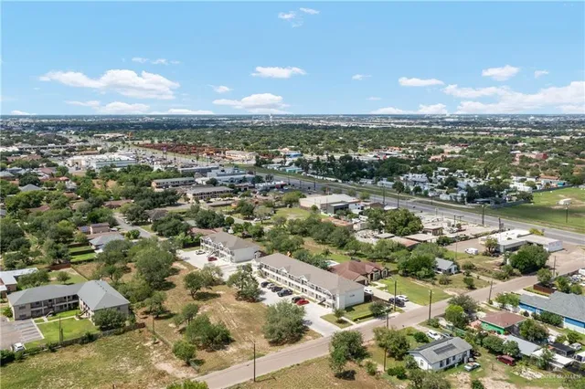 an aerial view of residential houses with outdoor space