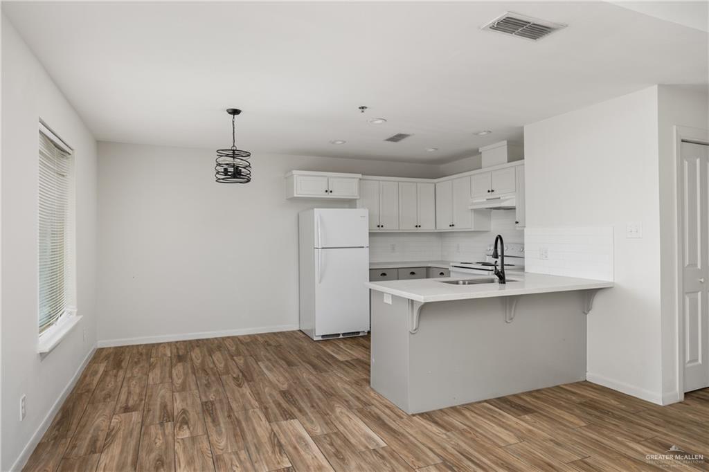 524 King Road, Unit 18 San Juan, TX 78589 - Photo 3 of 12 a kitchen with stainless steel appliances a sink cabinets and wooden floor