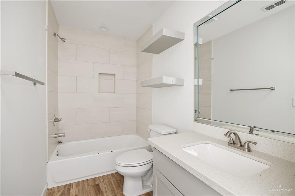 524 King Road, Unit 18 San Juan, TX 78589 - Photo 8 of 12 a bathroom with a sink a toilet and shower