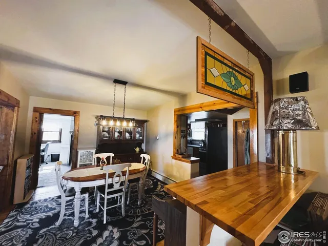 a living room with furniture and chandelier