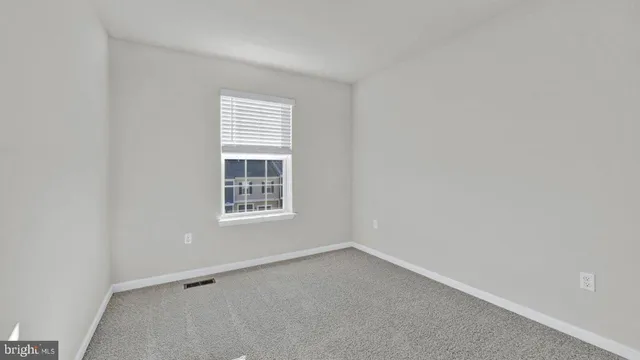a front view of a house with porch and sitting area