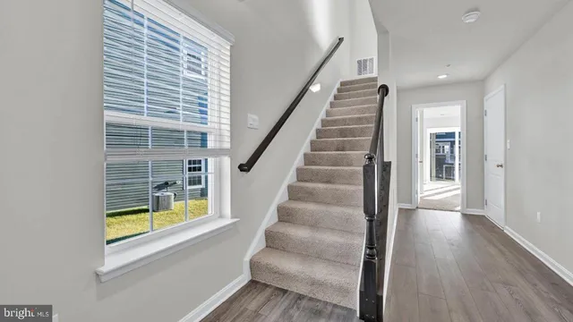 an empty room with floor to ceiling windows and carpet