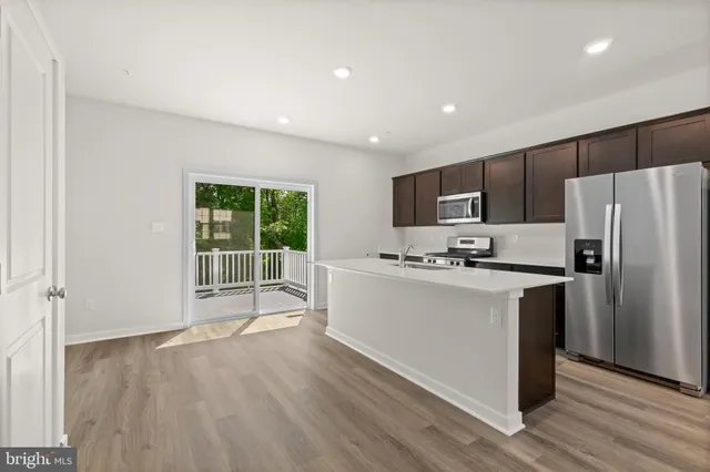 a kitchen with stainless steel appliances a sink and a stove