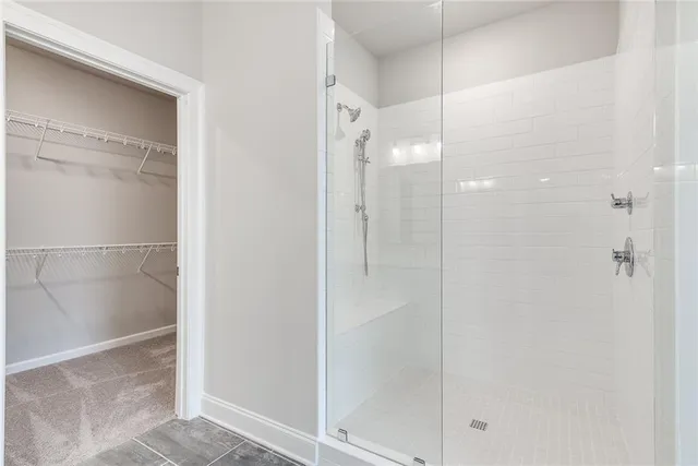 a bathroom with a glass shower door