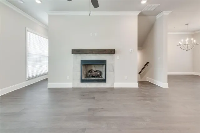 an empty room with windows and fireplace
