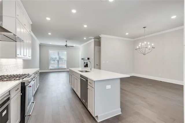 a kitchen with a stove and a wooden floor