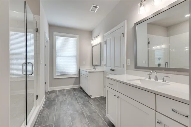 a bathroom with a double vanity sink mirror and
