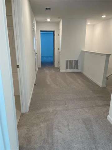 a view of an empty room and closet area