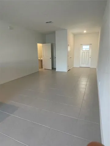 a large white kitchen with a large window