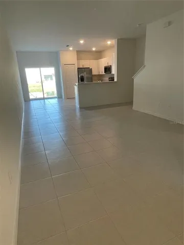 a kitchen with stainless steel appliances a refrigerator sink and microwave