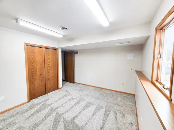 a view of a room with a wooden floor and entryway