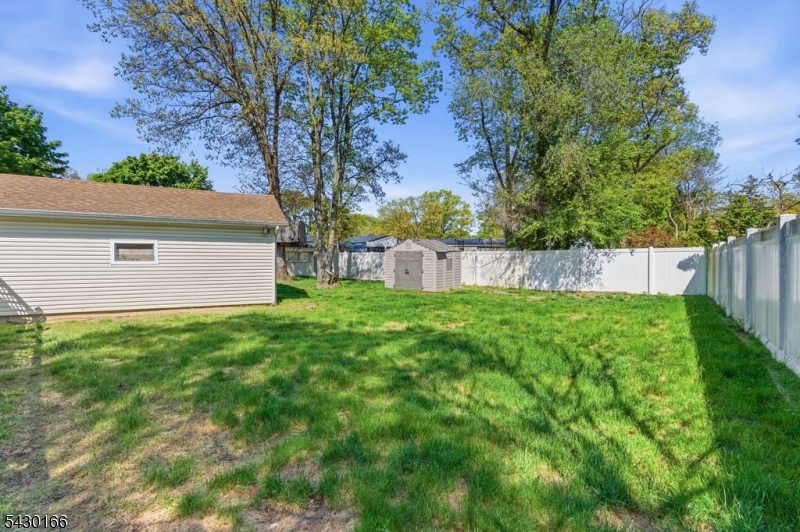 38 Clark Drive Howell, NJ 07731 - Photo 10 of 15 a view of a backyard with a large tree