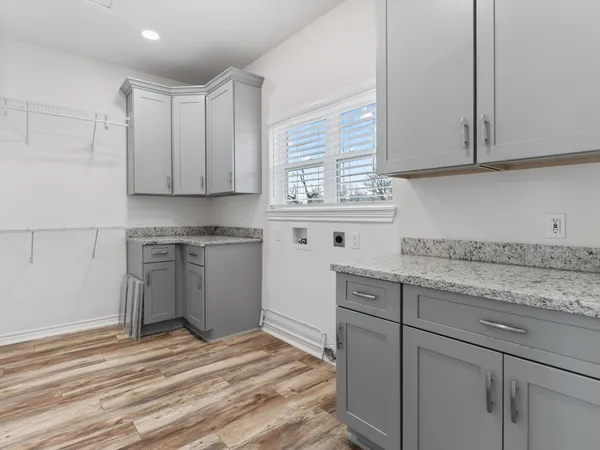 a kitchen with stainless steel appliances granite countertop a sink a stove and cabinets