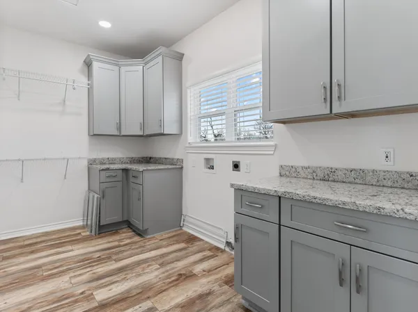a kitchen with stainless steel appliances granite countertop a sink a stove and cabinets