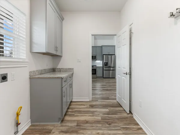 a kitchen with a refrigerator sink and cabinets