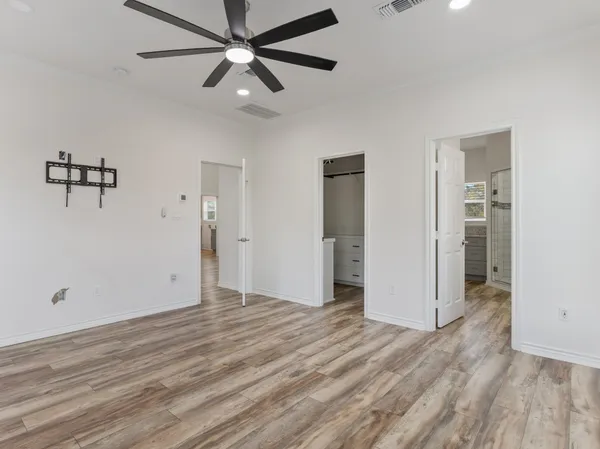 a view of an empty room with wooden floor