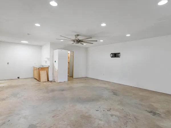 an empty room with closet and windows