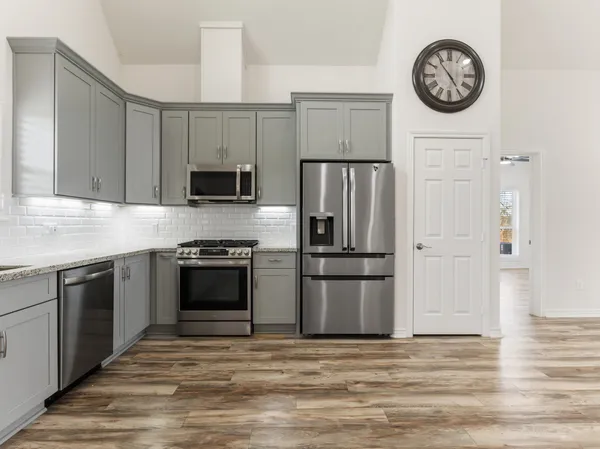 a kitchen with a refrigerator stove and a sink