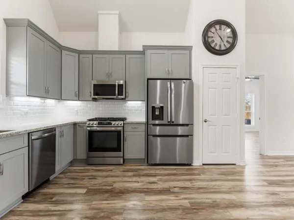 a kitchen with a refrigerator stove and a sink