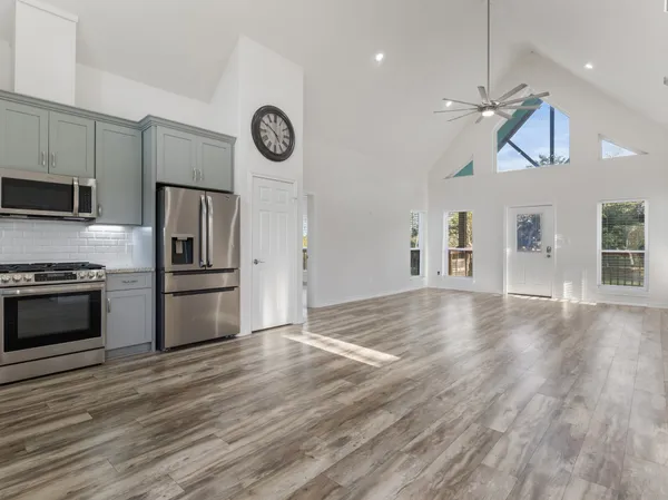 a view of kitchen with sink microwave and refrigerator