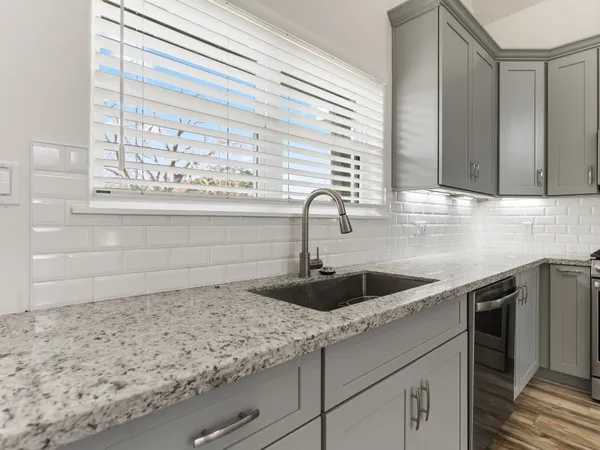 a kitchen with a sink and cabinets
