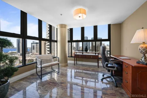 a living room with furniture and large windows