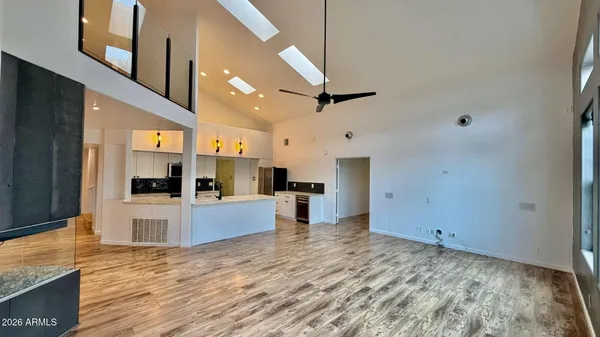 a view of a kitchen with kitchen island a counter top space a sink and stainless steel appliances
