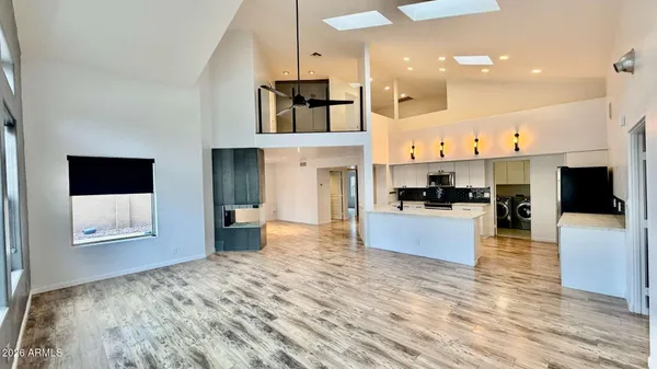 a large kitchen with cabinets a sink and a stove