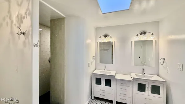 a view of bathroom with dual sinks