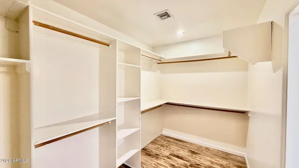 a view of a room with wooden floor