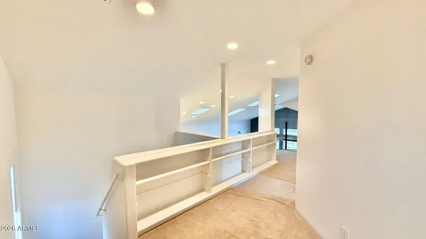 an empty room with a ceiling fan and a window