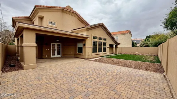 a front view of a house with a garden and yard