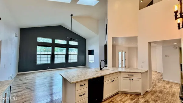 a spacious bathroom with a granite countertop sink and a large mirror