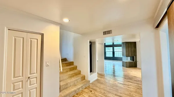 a view of a hallway view with wooden floor and staircase