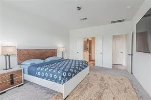 a bedroom with a bed and a lamp